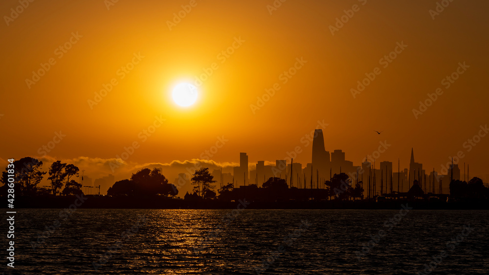 Sunset of the skyline of San Francisco Ca. seen from Alameda beach at golden hour