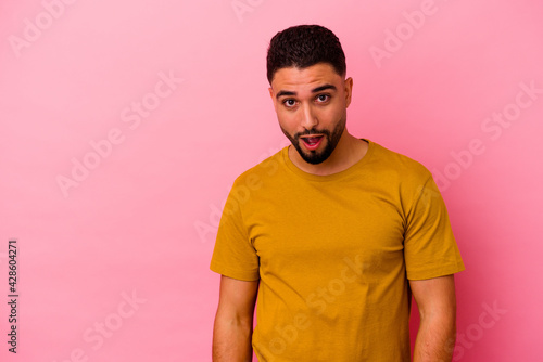 Young mixed race man isolated on pink background