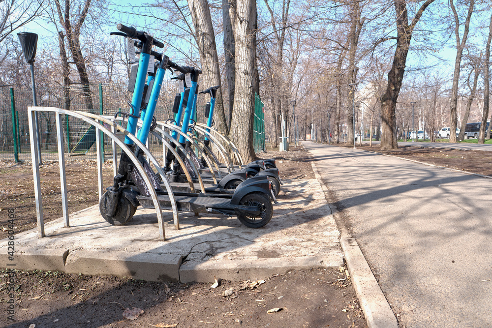 03.04.2021 Kazakhstan, Almaty. Scooters for rent in the parking lot. Eco-friendly transport 03.04.2021 Kazakhstan, Almaty. Scooters for rent in the parking lot. Eco-friendly transport