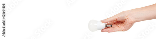 Hand with white LED bulb isolated on white background.