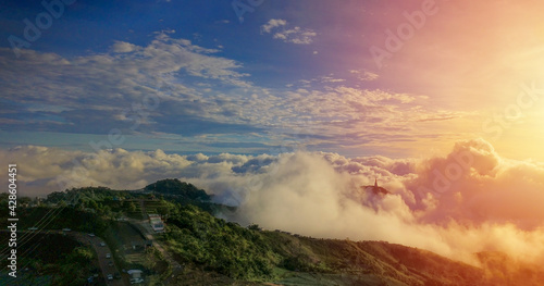 Mountains under the mist in the morning with sunshine, blue sky and sun light.