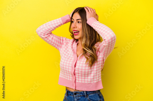 Young caucasian woman isolated on yellow background