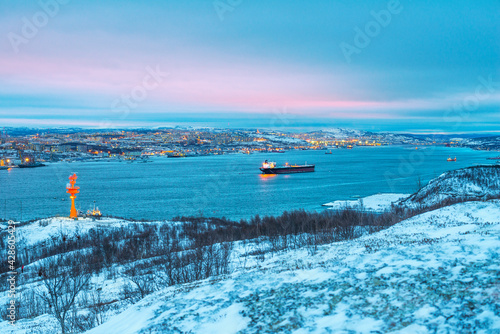 Murmansk, snow, Kola Bay, ships in the roads.

Murmansk seaport is the only non-freezing Northern port of Russia, and only because the Gulf Stream enters the Kola Bay (Barents Sea)