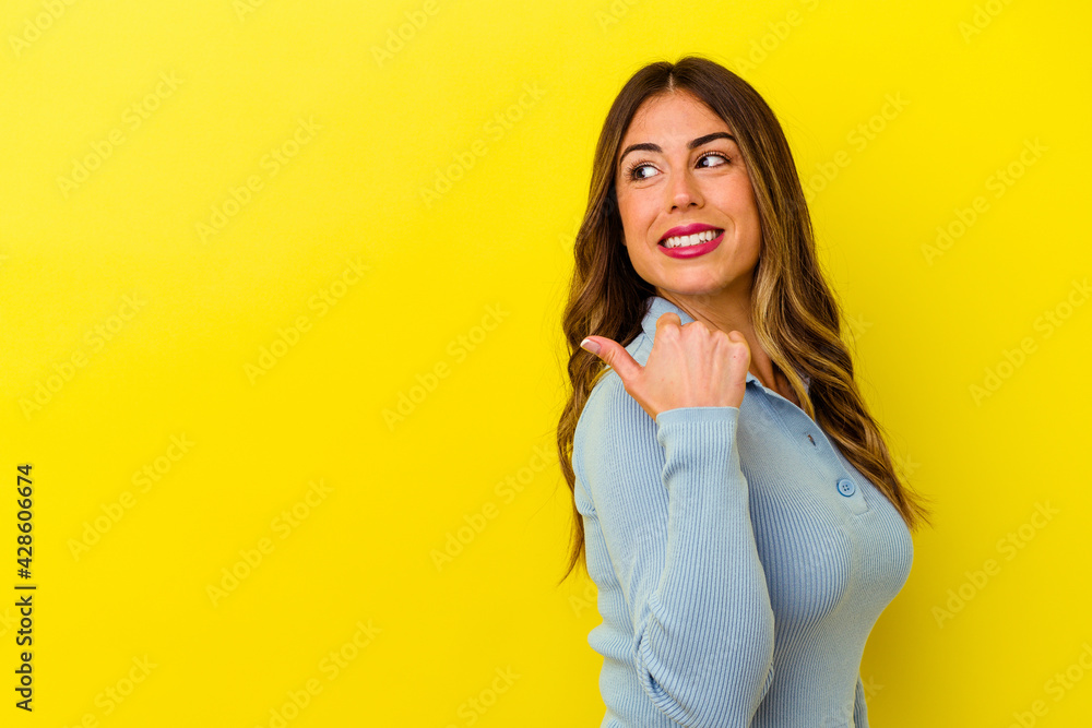 Fototapeta premium Young caucasian woman isolated on yellow background