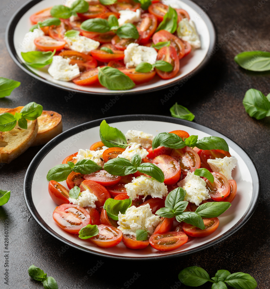 Caprese salad with cherry plum tomatoes, mozzarella cheese and basil. Healthy vegetarian food Caprese salad with cherry plum tomatoes, mozzarella cheese and basil. Healthy vegetarian food