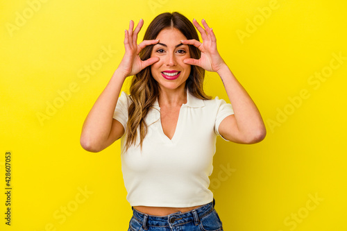 Young caucasian woman isolated on yellow background