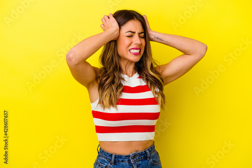 Young caucasian woman isolated on yellow background