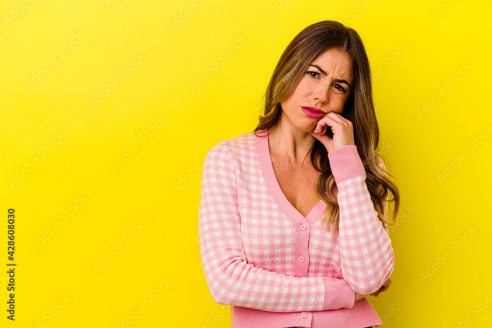 Young caucasian woman isolated on yellow background