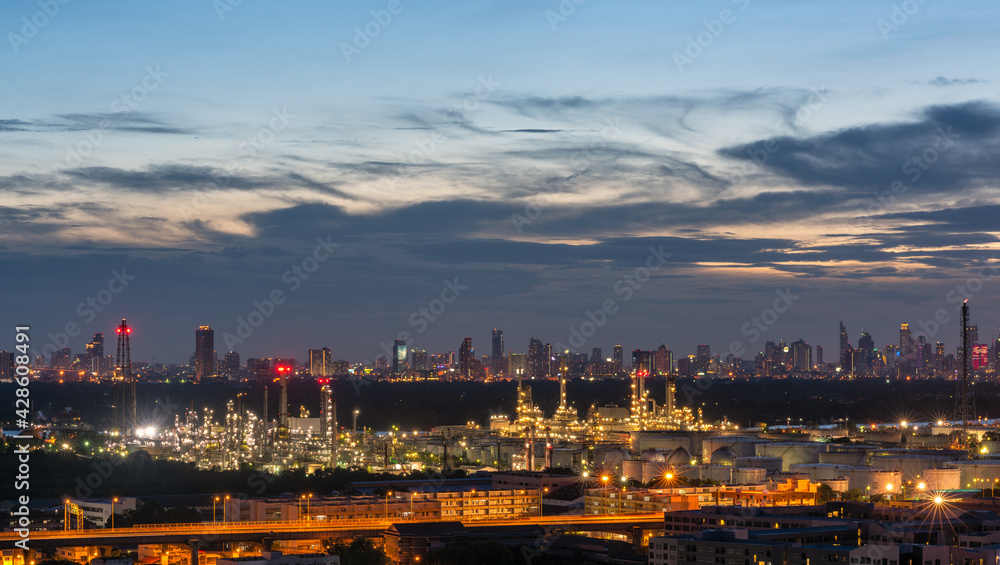 Obraz premium Oil refinery plant industry zone, Aerial view oil and gas petrochemical Refinery factory oil storage tank and pipeline steel at , Ecosystem and Safety Twilight sky Evening City Backdrop