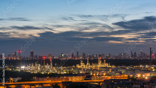 Oil refinery plant industry zone, Aerial view oil and gas petrochemical Refinery factory oil storage tank and pipeline steel at , Ecosystem and Safety Twilight sky Evening City Backdrop