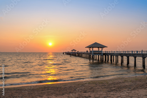 A wooden bridge in the sea with a sunset view © boygek