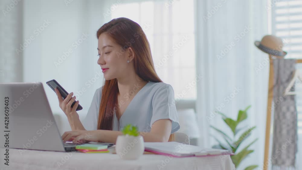 beautiful business asian woman working online with laptop answer the call talking in mobile phone to success job at home,Freelance woman working online sale marketing,Small Business Startup concept beautiful business asian woman working online with laptop answer the call talking in mobile phone to success job at home,Freelance woman working online sale marketing,Small Business Startup concept