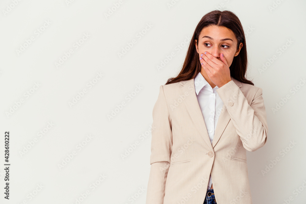 Young Indian business woman isolated on white background thoughtful looking to a copy space covering mouth with hand. Young Indian business woman isolated on white background thoughtful looking to a copy space covering mouth with hand.