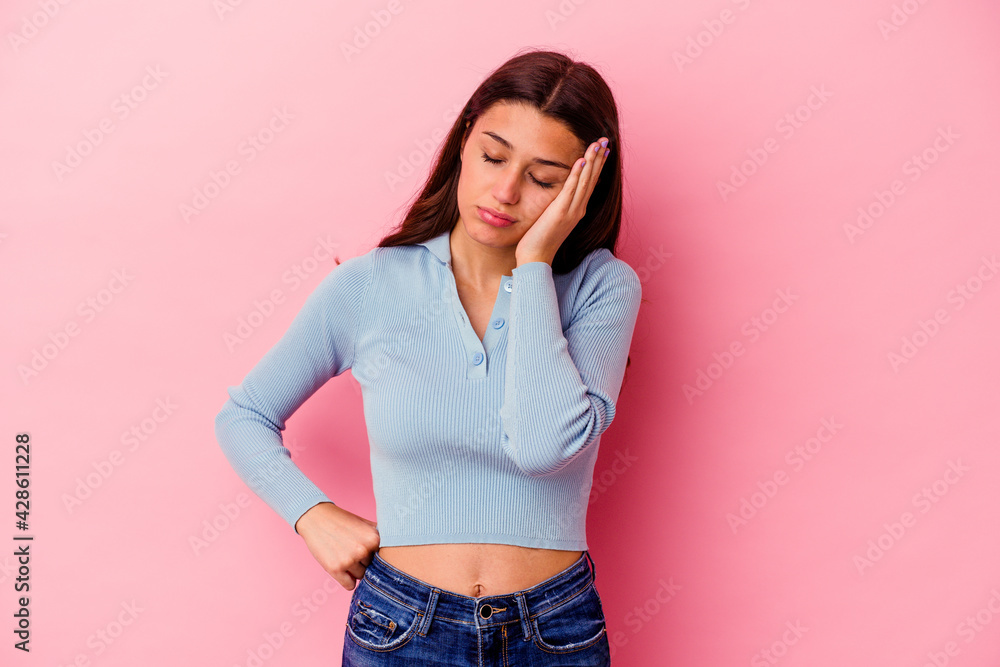 Young Indian woman isolated on pink background tired and very sleepy keeping hand on head. Young Indian woman isolated on pink background tired and very sleepy keeping hand on head.