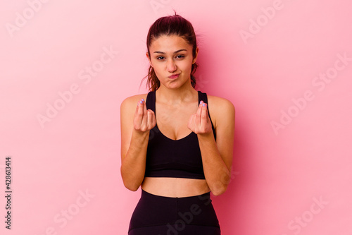 Young sport Indian woman isolated on pink background showing that she has no money. © Asier