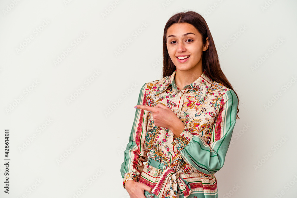 Young Indian woman isolated on white background smiling and pointing aside, showing something at blank space. Young Indian woman isolated on white background smiling and pointing aside, showing something at blank space.