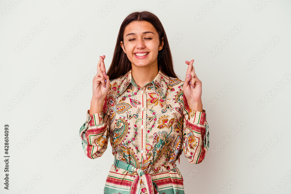 Young Indian woman isolated on white background crossing fingers for having luck Young Indian woman isolated on white background crossing fingers for having luck