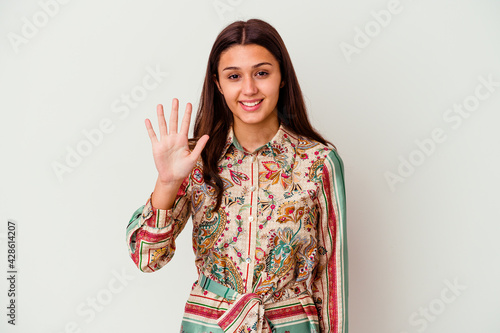 Young Indian woman isolated on white background smiling cheerful showing number five with fingers.