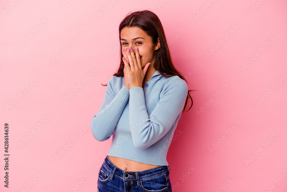 Young Indian woman isolated on pink background laughing about something, covering mouth with hands. Young Indian woman isolated on pink background laughing about something, covering mouth with hands.