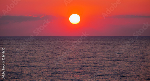 Fototapeta Naklejka Na Ścianę i Meble -  Amazing red sunset with yellow sun over the sea - Side, Turkey