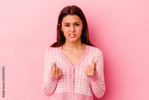 Young Indian woman isolated on pink background showing that she has no money.