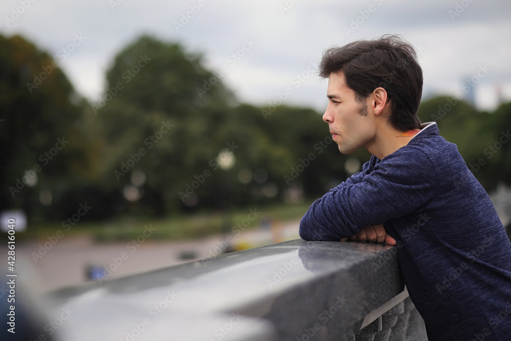 A young man walks in the park at lunch time. A man is on a walk in the city. A student in the park. A young man walks in the park at lunch time. A man is on a walk in the city. A student in the park.