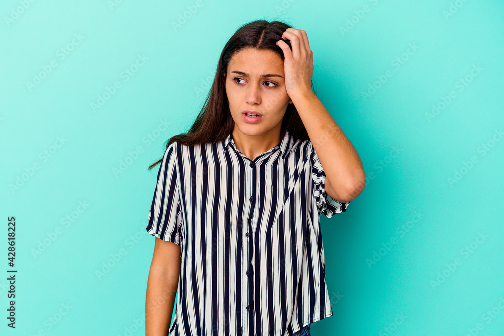 Young Indian woman isolated on blue background being shocked, she has remembered important meeting. Young Indian woman isolated on blue background being shocked, she has remembered important meeting.