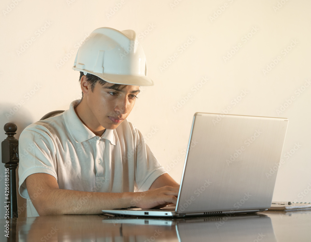 young latin engineer designs on his computer at home, teleworking
young latin engineer designs on his computer at home, teleworking