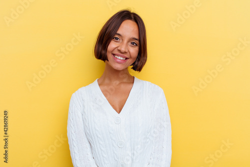 Young mixed race woman isolated on yellow background happy, smiling and cheerful.