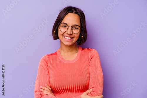 Young mixed race woman isolated on purple background laughing and having fun.