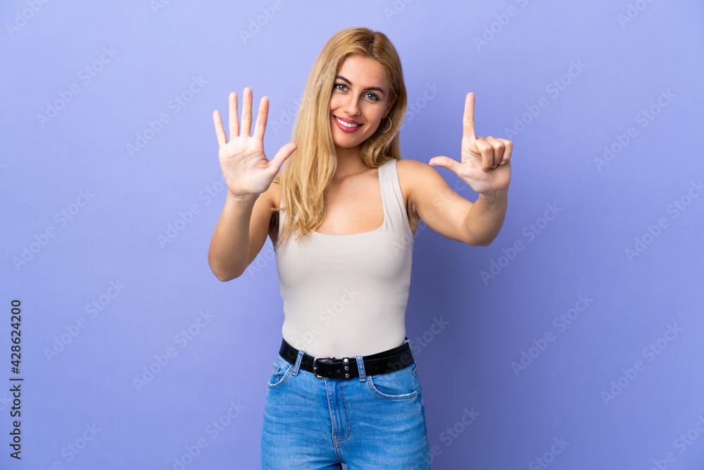 Young Uruguayan blonde woman over isolated background counting seven with fingers Young Uruguayan blonde woman over isolated background counting seven with fingers