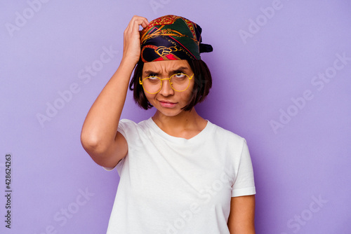 Young mixed race woman wearing a bandana isolated on purple background being shocked, she has remembered important meeting.
