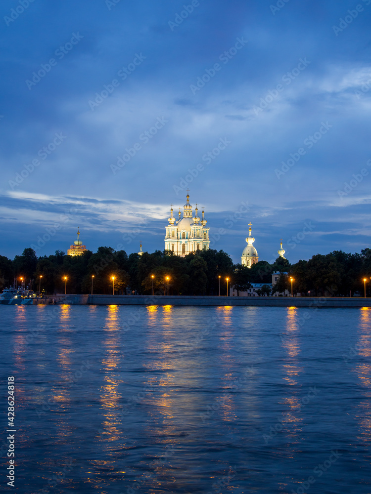 Obraz premium Russia, St. Petersburg - July 19, 2020: View of the Smolny Cathedral from the Neva at night on a cloudy summer day. Russia, Saint-Petersburg