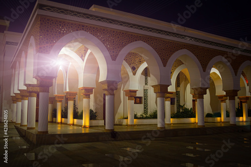 Night view of arcade gallery of Mosque at the port of Tangier, Morocco. Exterior building with arched colonnade. Muslim evening prayer time © Вера Тихонова