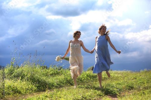 Young girls are walking in the field