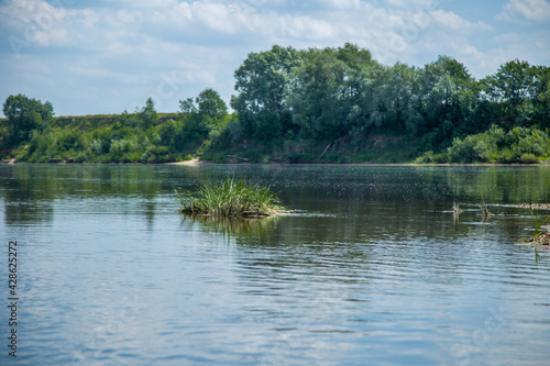 View of the Oka river from the shore, the opposite Bank is visible . The sky is reflected in the water
