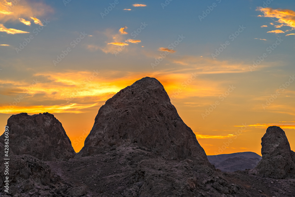 Sunset sky over tall rock peak