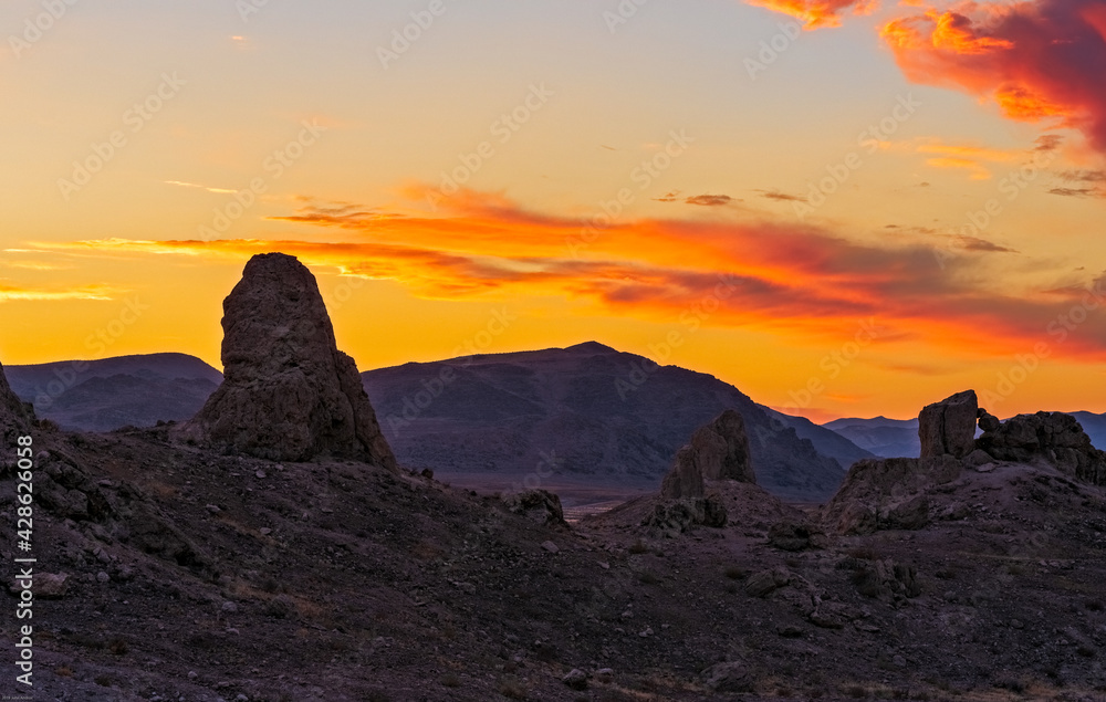 Sunset over Pinnacles with mountain beyond.