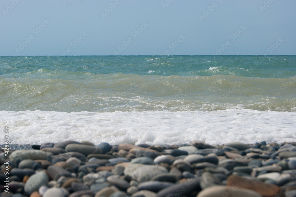 The Sea Wave of the Black Sea is a pebble beach. Smooth horizon, blue sky. The Sea Wave of the Black Sea is a pebble beach. Smooth horizon, blue sky.