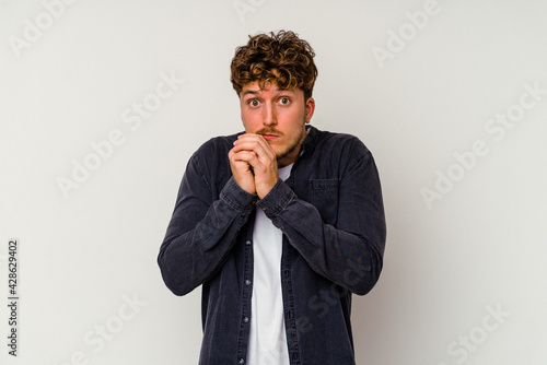 Young caucasian man isolated on white background scared and afraid.