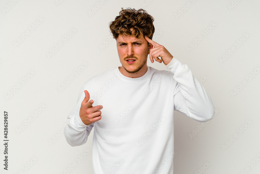 Young caucasian man isolated on white background showing a disappointment gesture with forefinger. Young caucasian man isolated on white background showing a disappointment gesture with forefinger.