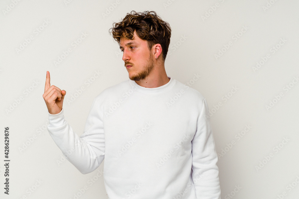 Young caucasian man isolated on white background pointing with finger at you as if inviting come closer. Young caucasian man isolated on white background pointing with finger at you as if inviting come closer.