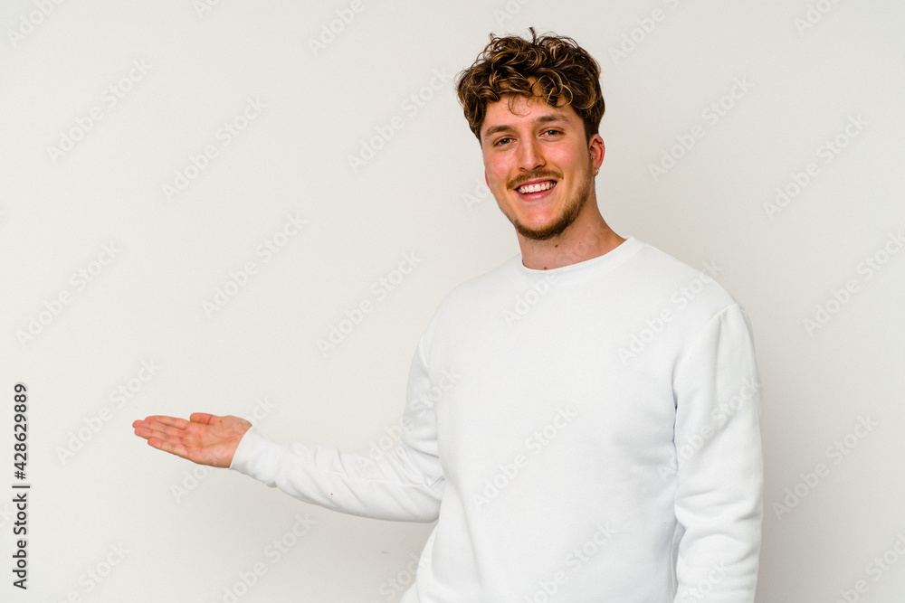 Young caucasian man isolated on white background showing a welcome expression.