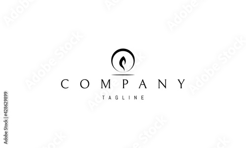 Vector logo on which an abstract image of a candle flame in a circle.