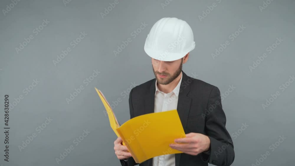 Serious business man in suit Checking folders with papers. Man in white protective hard hat 4K Serious business man in suit Checking folders with papers. Man in white protective hard hat 4K