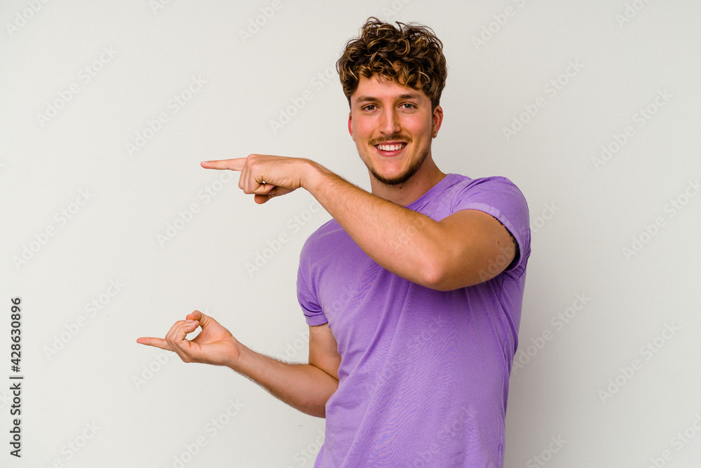 Young caucasian man isolated on white background holding something little with forefingers, smiling and confident. Young caucasian man isolated on white background holding something little with forefingers, smiling and confident.