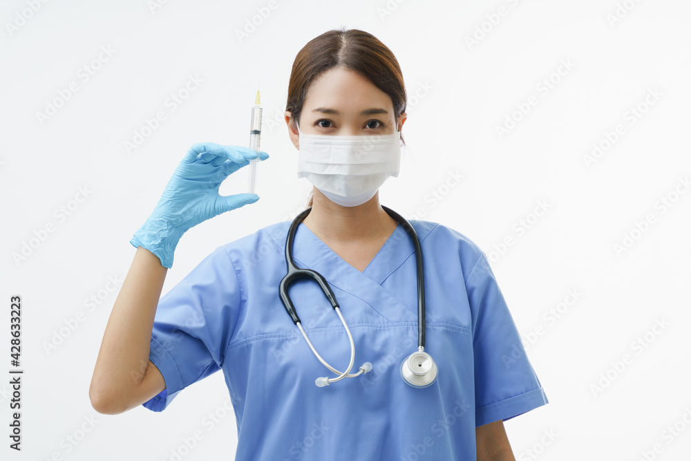 Medium close up portrait of Asian female doctor or nurse wearing protective face mask hold up syringe and stand over white background with copy space. Concept preparing to get vaccine. Medium close up portrait of Asian female doctor or nurse wearing protective face mask hold up syringe and stand over white background with copy space. Concept preparing to get vaccine.