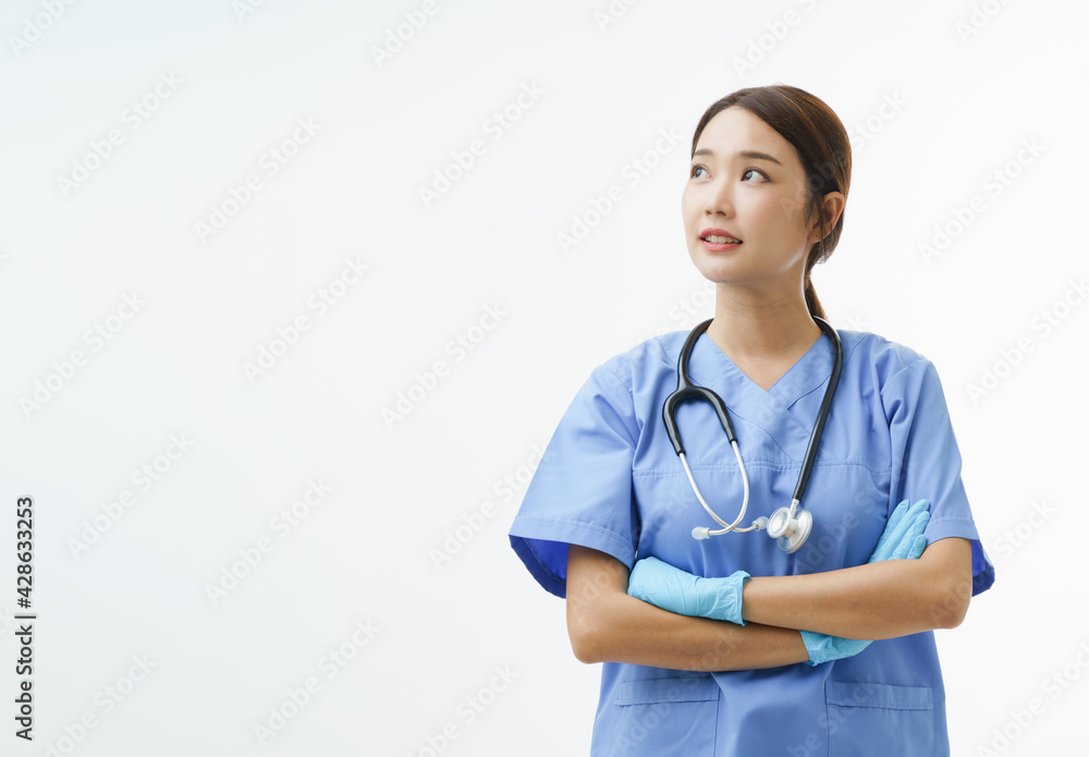 Medium close up portrait of Asian female doctor or nurse wearing gloves cross her arm and look up on her right direction stand over white background with copy space. Concept of Health care hero.