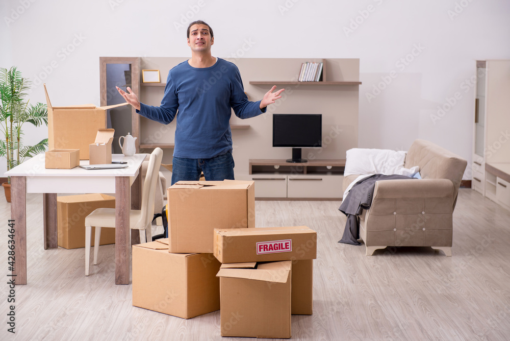 Young man moving to new flat Young man moving to new flat