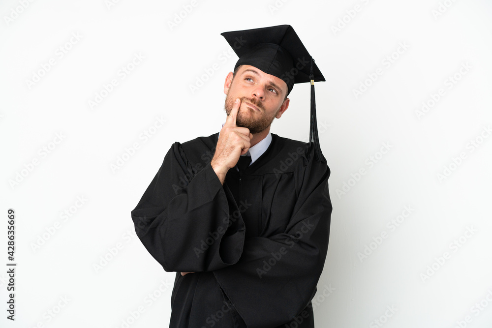 Young university Brazilian graduate isolated on white background having doubts while looking up Young university Brazilian graduate isolated on white background having doubts while looking up